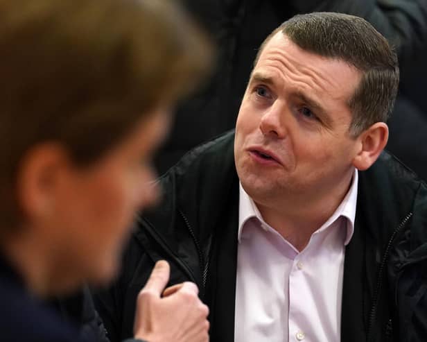 Scottish Conservative leader Douglas Ross alongside First Minister Nicola Sturgeon during a joint visit to the Bluevale Community Hall in Glasgow.  Andrew Milligan/PA Wire