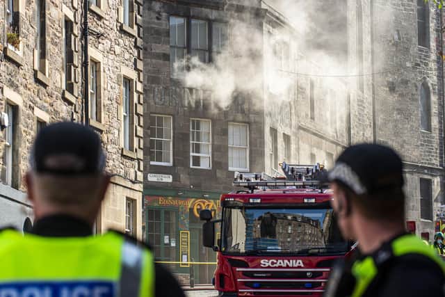 One firefighter was taken to hospital after the level-four inferno.




Fire crews have been tackling a large blaze which broke out at Edinburgh's George IV Bridge.



Police Scotland closed several roads in the city's old town on Tuesday morning and said officers were assisting the Scottish Fire and Rescue Service .



The alarm was raised shortly after 6am by a cleaner at Edinburgh's Elephant House cafe - where JK Rowling penned her first Harry Potter book.



It is believed the fire started in the Patisserie Valerie cafe next door.



Elephant House owner David Taylor, said the fire had not spread to the building, but it had suffered smoke and water damage.