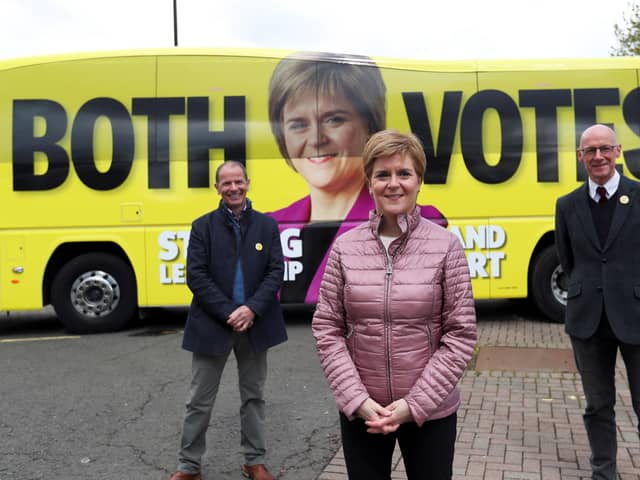First Minister Nicola Sturgeon with SNP candidate Jim Fairlie and Deputy First Minister John Swinney at Perth Farmer's Market in Perth. Picture: Russell Cheyne/PA Wire