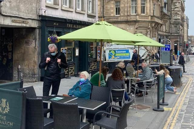 A pint in a beer garden or at a table in an outdoor eating area is now allowed, after months of strict lockdown restrictions. Here are some people taking a seat at Albanach in High Street, Edinburgh. Photo: Matt Donlan