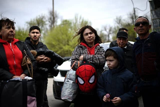Ukrainian refugees wait to board a bus in the Moldovan capital Chisinau.