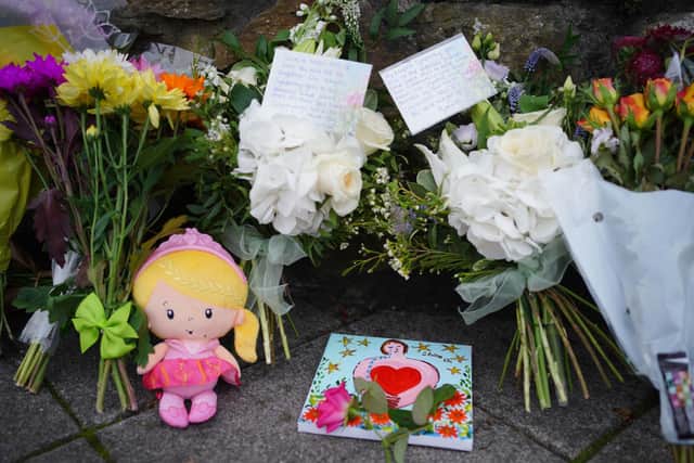 People leave flowers in the Keyham area of Plymouth, where six people - including the offender - died in a shooting spree on Thursday evening