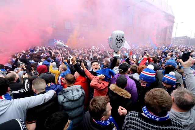 Rangers fans celebrate outside of the Ibrox Stadium after Rangers win the Scottish Premiership title. Picture date: Sunday March 7, 2021.