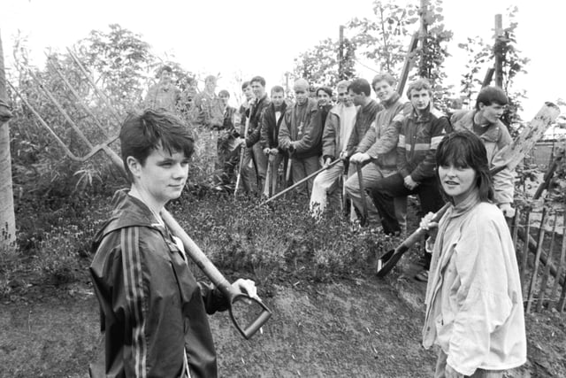 A group of teenagers on the Youth Training Scheme (YTS) with spades and forks at the Glasgow Garden Festival site in August 1987.