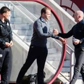 Hearts' and Livingston managers Robbie Neilson (L) and David Martindale (R) shake hands before kick-off during a cinch Premiership match between Heart of Midlothian and Livingston at Tynecastle Stadium, on March 19, 2022, in Edinburgh, Scotland. (Photo by Ross Parker / SNS Group)