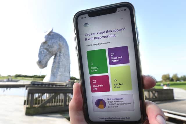 The Protect Scotland app from NHS Scotland is visible on a phone at the Kelpies in Falkirk, Central Scotland