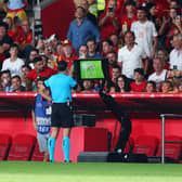 Referee Serdar Gozubuyuk checks the VAR monitor before disallowing the goal scored by Scott McTominay. (Photo by Fran Santiago/Getty Images)