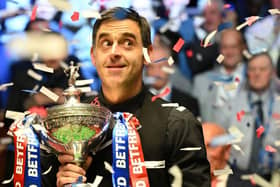 England's Ronnie O'Sullivan poses with the trophy after his victory over England's Judd Trump in the World Championship Snooker final at The Crucible in Sheffield, England on May 2, 2022.