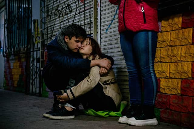 A young couple hugs while hiding in an underground during an air alert in Zaporizhzhia. Picture: Dimitar Dilkoff/AFP via Getty Images