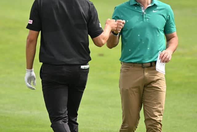 Rory McIlroy is congratulated by playing partner Nicolai Hojgaard after holing out for an eagle at the third hole. Picture: Stuart Franklin/Getty Images.