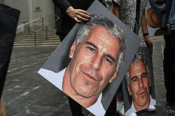 A protest group called "Hot Mess" hold up signs of Jeffrey Epstein in front of the Federal courthouse in New York. Picture:  Stephanie Keith/Getty Images