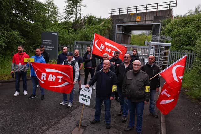 Striking sail staff picket outside Cowlairs maintenance depot and signal centre on June 21, 2022 in Glasgow, Scotland. The biggest rail strikes in 30 years started on Monday night with trains cancelled across the UK for much of the week. The action is being taken by Network Rail employees plus onboard and station staff working for 13 train operators across England (Photo by Jeff J Mitchell/Getty Images).