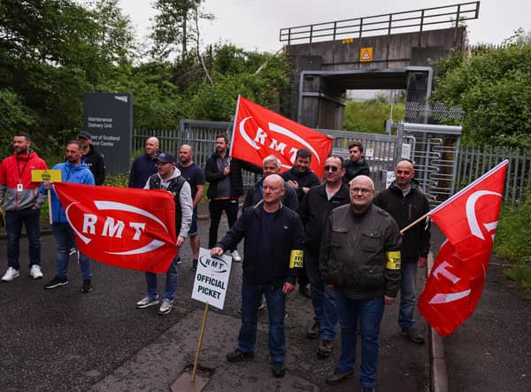 Striking sail staff picket outside Cowlairs maintenance depot and signal centre on June 21, 2022 in Glasgow, Scotland. The biggest rail strikes in 30 years started on Monday night with trains cancelled across the UK for much of the week. The action is being taken by Network Rail employees plus onboard and station staff working for 13 train operators across England (Photo by Jeff J Mitchell/Getty Images).