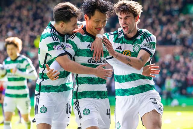 Celtic's Reo Hatate celebrates with Nicolas Kuhn and Matt O'Riley.