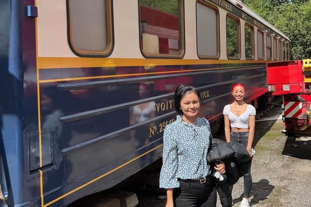 Isara and Mia McCallum beside the Mission Impossible 7 carriage they have bought to convert into a Thai restaurant. Picture: Fergus McCallum