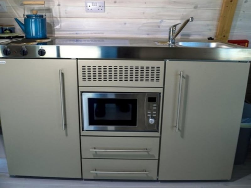 The designer kitchen includes a hob and microwave.