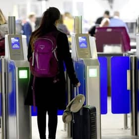 A passenger scans their passport at Edinburgh Airport. Picture: Lisa Ferguson