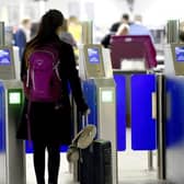 A passenger scans their passport at Edinburgh Airport. Picture: Lisa Ferguson