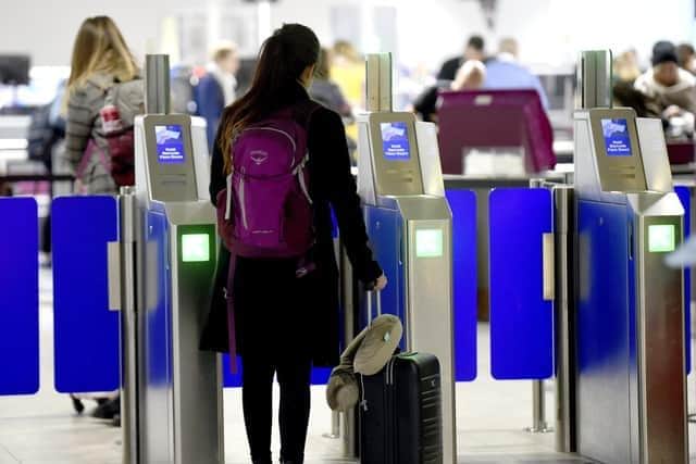 A passenger scans their passport at Edinburgh Airport. Picture: Lisa Ferguson