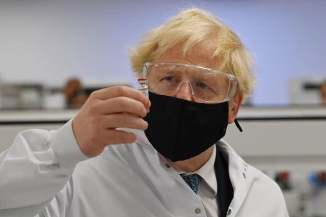 Prime Minister Boris Johnson holds a vial of the Oxford/AstraZeneca vaccine Covid-19 candidate vaccine, known as AZD1222, at Wockhardt's pharmaceutical manufacturing facility in Wrexham, North Wales. Picture: Paul Ellis/PA Wire