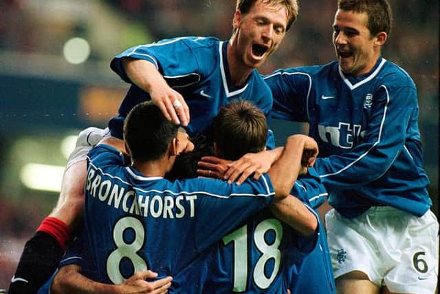 Giovanni van Bronckhorst celebrates with his team-mates after Rangers had opened the scoring against Parma in their Champions League qualifier against Parma at Ibrox in August 1999. (Photo by SNS Group).