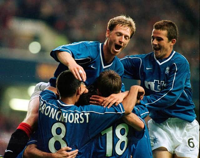 Giovanni van Bronckhorst celebrates with his team-mates after Rangers had opened the scoring against Parma in their Champions League qualifier against Parma at Ibrox in August 1999. (Photo by SNS Group).