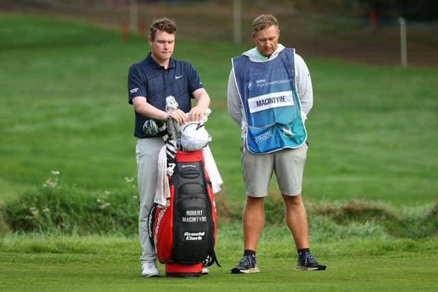 Bob MacIntyre and his caddie Mike Thomson pays their respects out on the course at Wentworth. Picture:  Andrew Redington/Getty Images.