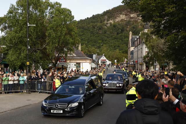 People gather in tribute in Ballater as the cortege carrying the coffin of the late Queen Elizabeth II passes by on September 11, 2022. PIC: (Photo by Jeff J Mitchell/Getty Images)