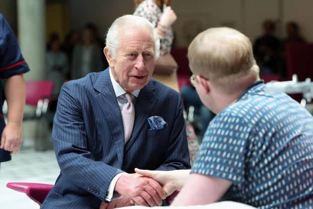 King Charles III, patron of Cancer Research UK and Macmillan Cancer Support, meets with patient Jasper Keech during a visit to University College Hospital Macmillan Cancer Centre in London. Picture: Suzanne Plunkett/PA Wire