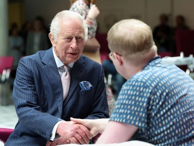 King Charles III, patron of Cancer Research UK and Macmillan Cancer Support, meets with patient Jasper Keech during a visit to University College Hospital Macmillan Cancer Centre in London. Picture: Suzanne Plunkett/PA Wire