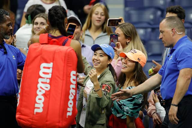Raducanu smiles for selfies with the New York crowd after defeating Maria Sakkari.
