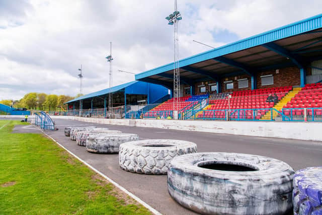 Central Park, home of Cowdenbeath, where monster truck tyres separate the football pitch from the stock car racing track.