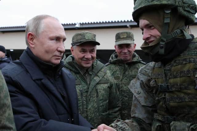 Russian President Vladimir Putin and Defence Minister Sergei Shoigu meet soldiers outside the town of Ryazan in October. An airfield near the town was one of two which were allegedly hit by missiles.
