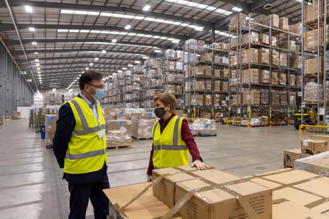 First Minister Nicola Sturgeon is given a tour by Gordon Beattie, Director of National Procurement for NHS National Services Scotland, during a visit to the NHS National Services Scotland Titan logistics facility on March 2, 2022 in Bellshill, Scotland. Photo by Pool/Getty Images