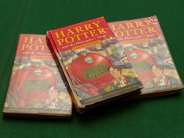 Undated handout photo issued by Hansons auctioneers of three first editions of Harry Potter and The Philosopher's Stone, including a rare hardback, rescued from a school's skip that are going up for auction on May 21, when they are expected to fetch thousands.