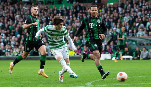 Kyogo Furuhashi slides the ball home to put Celtic ahead against Ferencvaros.