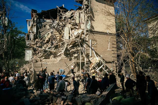 Volunteers search for survivors after a Russian missile strike on Zaporizhzhia (Picture: Dimitar Dilkoff/AFP via Getty Images)