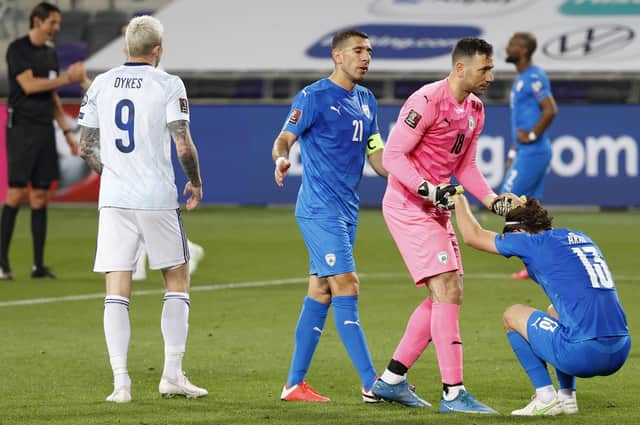 Players react to the draw at the end of the 2022 FIFA World Cup qualifier group F football match between Israel and Scotland at Bloomfield stadium in the Israeli Mediterranean coastal city of Tel Aviv on March 28, 2021. (Photo by JACK GUEZ / AFP) (Photo by JACK GUEZ/AFP via Getty Images)
