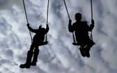 Children enjoying playing on swings in a park.