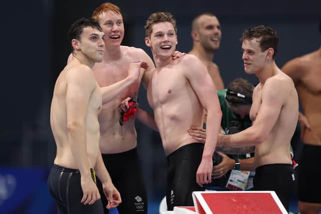 Duncan Scott, centre, grins in triumph alongside Team GB team-mates Tom Dean, James Guy and Matthew Richards after their triumph in the men's 4 x 200m freestyle relay final on day five of the Tokyo 2020 Olympic Games. Picture: Tom Pennington/Getty Images