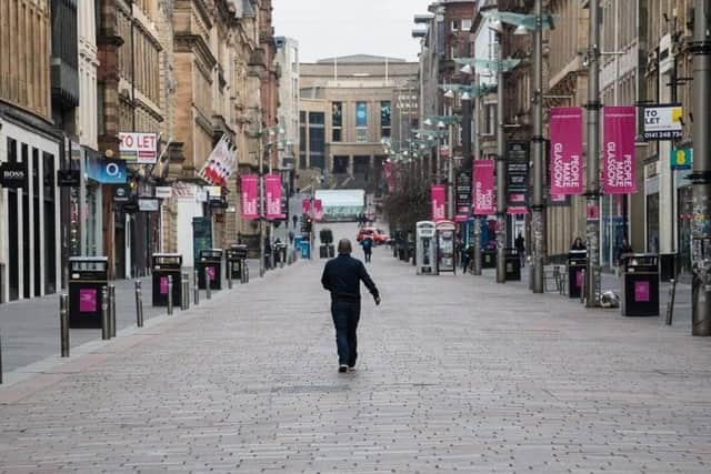 A pedestrian walks along an empty George Street