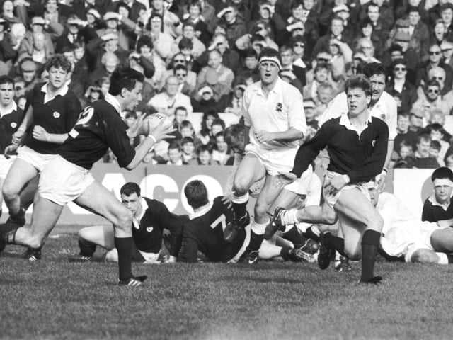 Scotland's Craig Chalmers passes to Sean Lineen (left) in the Scotland v England Calcutta Cup match.