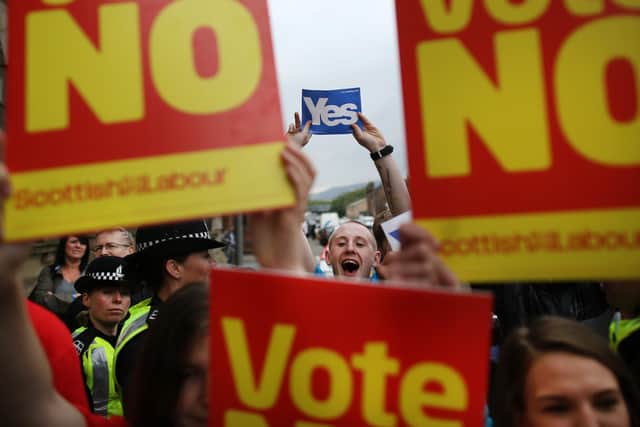 Supporters of the Yes and No campaigns gather outside Dumbarton Town Hall in September 2014 ahead of the Scottish independence referendum (Picture: Peter Macdiarmid/Getty Images)