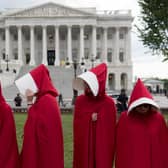 Supporters of sexual health body Planned Parenthood dress as characters from The Handmaid's Tale as they protest outside the US Senate (Picture: Saul Loeb/AFP via Getty Images)