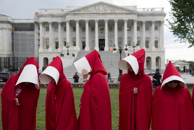 Supporters of sexual health body Planned Parenthood dress as characters from The Handmaid's Tale as they protest outside the US Senate (Picture: Saul Loeb/AFP via Getty Images)