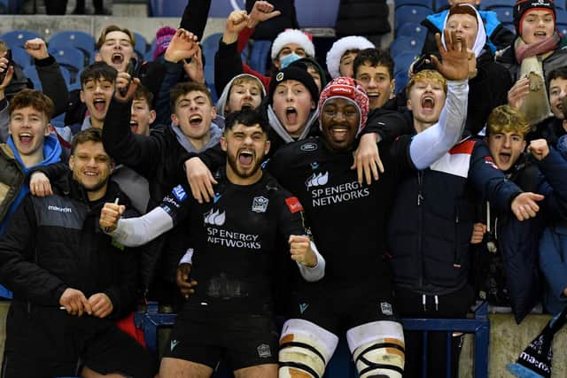 Rufus McLean and Sintu Manjezi celebrate with Warriors fans at full time after the win over Perpignan at BT Murrayfield. (Photo by Ross MacDonald / SNS Group)