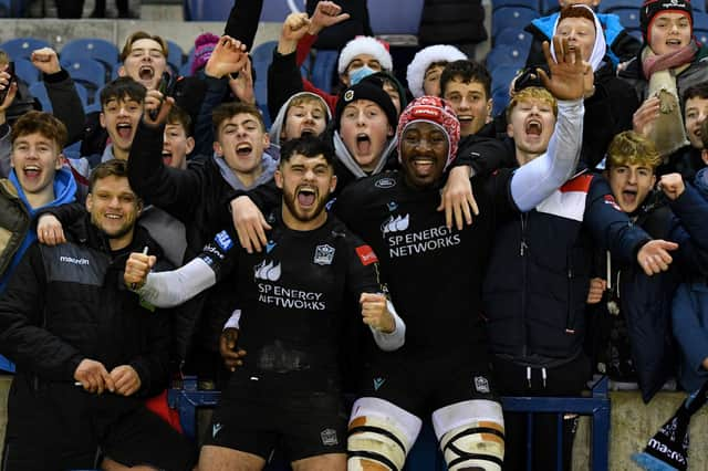 Rufus McLean and Sintu Manjezi celebrate with Warriors fans at full time after the win over Perpignan at BT Murrayfield. (Photo by Ross MacDonald / SNS Group)