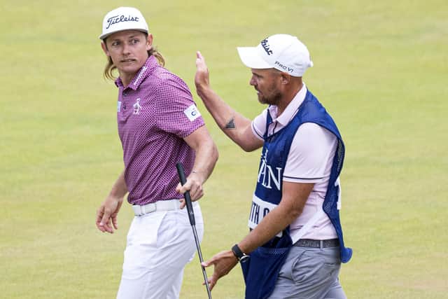 Cameron Smith hands his trusty putter to caddie Sam Pinfold during the final round on Sunday. Picture: Tom Russo