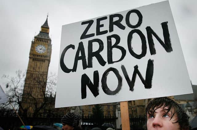 A climate change protestor calls for action on climate change, but carbon dioxide is not the only gas we need to worry about. Methane also plays a significant role.  (Picture: Peter Macdiarmid/Getty Images)