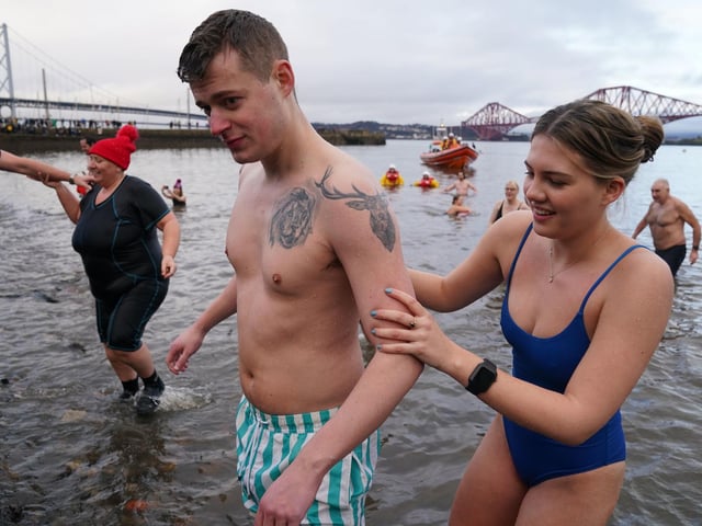 People take part in the Loony Dook New Year's Day dip in the Firth of Forth at South Queensferry